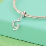 Ezüst charm, G betű