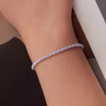 Ezüst karkötő lila zsinórral